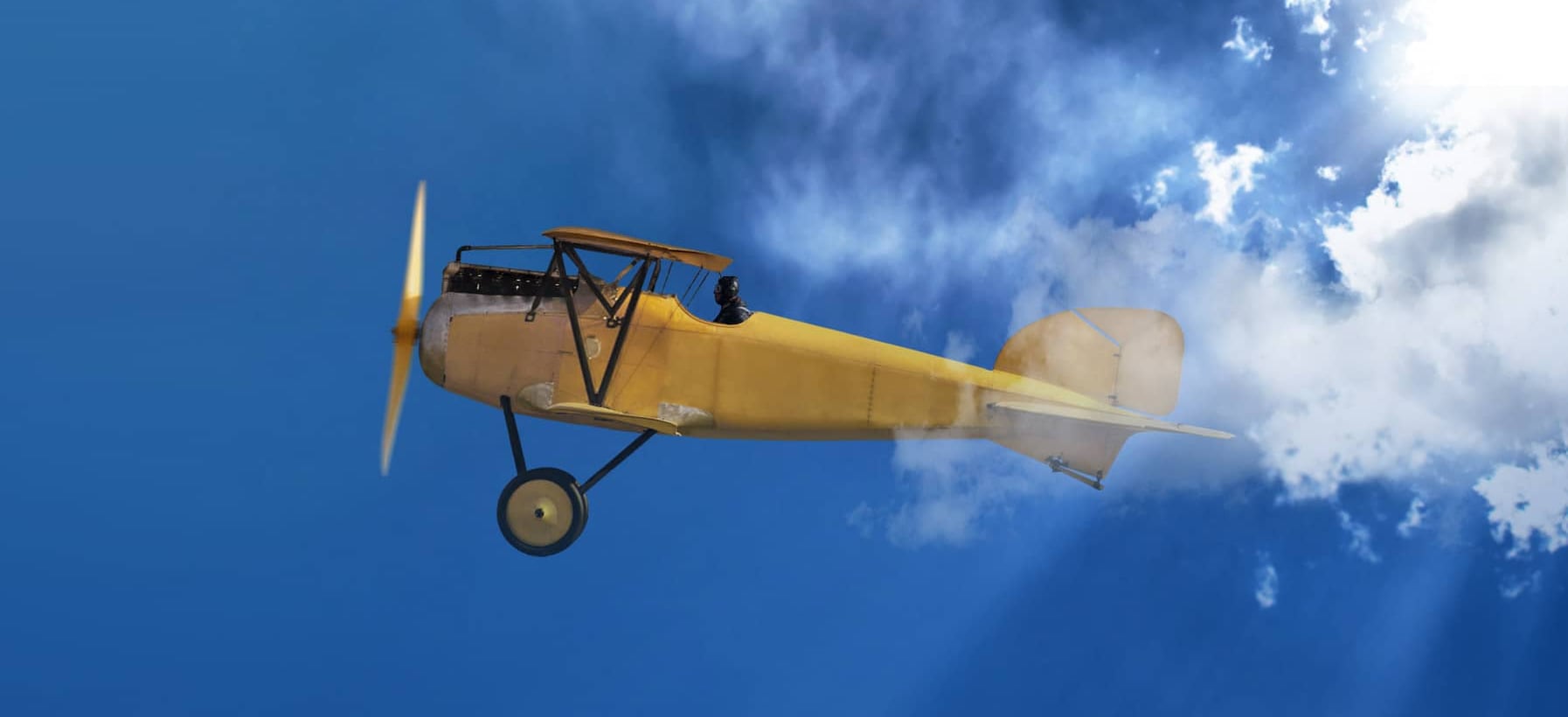 Yellow single engine plane in blue sky